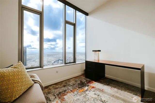 a living room with a bed furniture and a large window