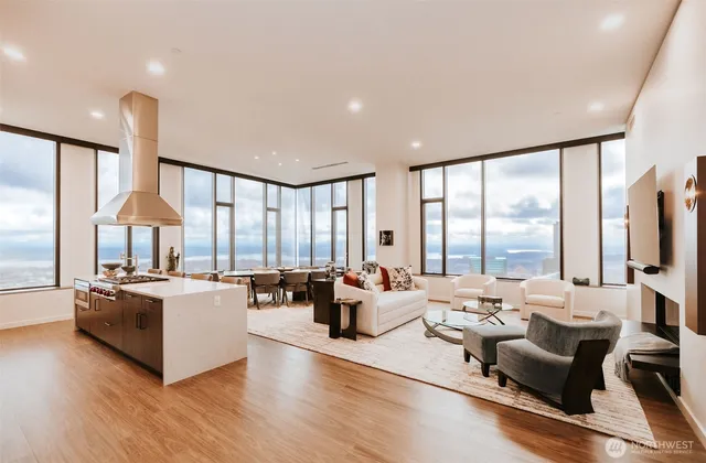 a living room with kitchen island furniture and a large window