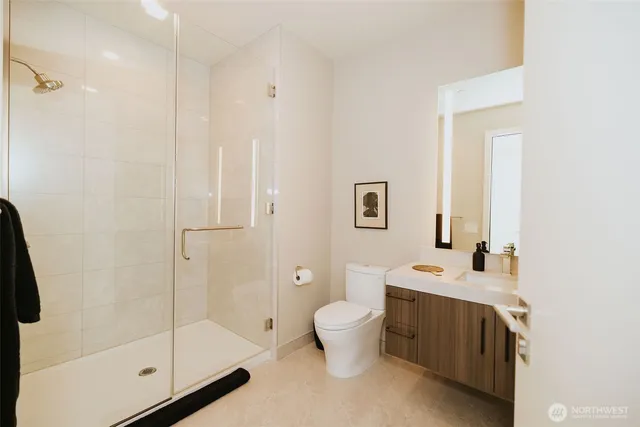 a bathroom with a double vanity sink toilet and shower