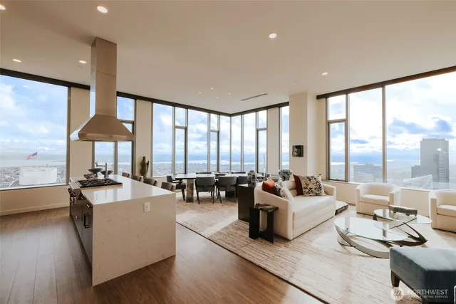 a living room with furniture and large windows