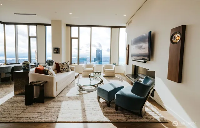 a living room with couches coffee table and a flat screen tv