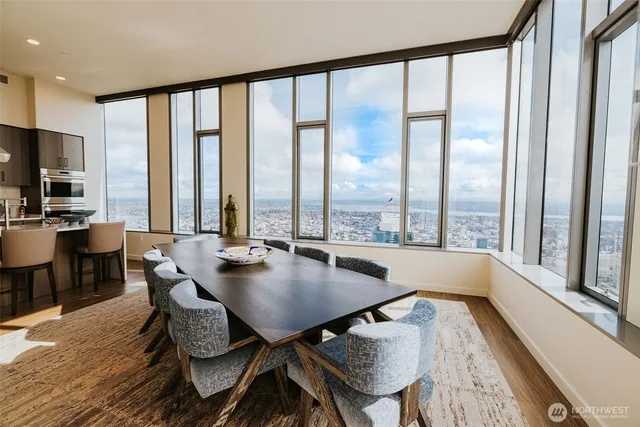a dining room with furniture and large windows