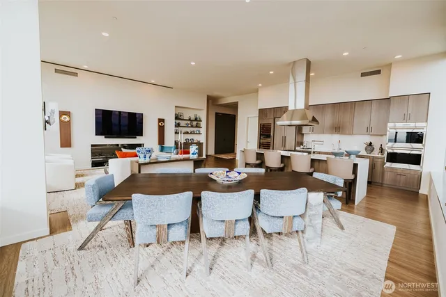 a living room with furniture a flat screen tv and kitchen view