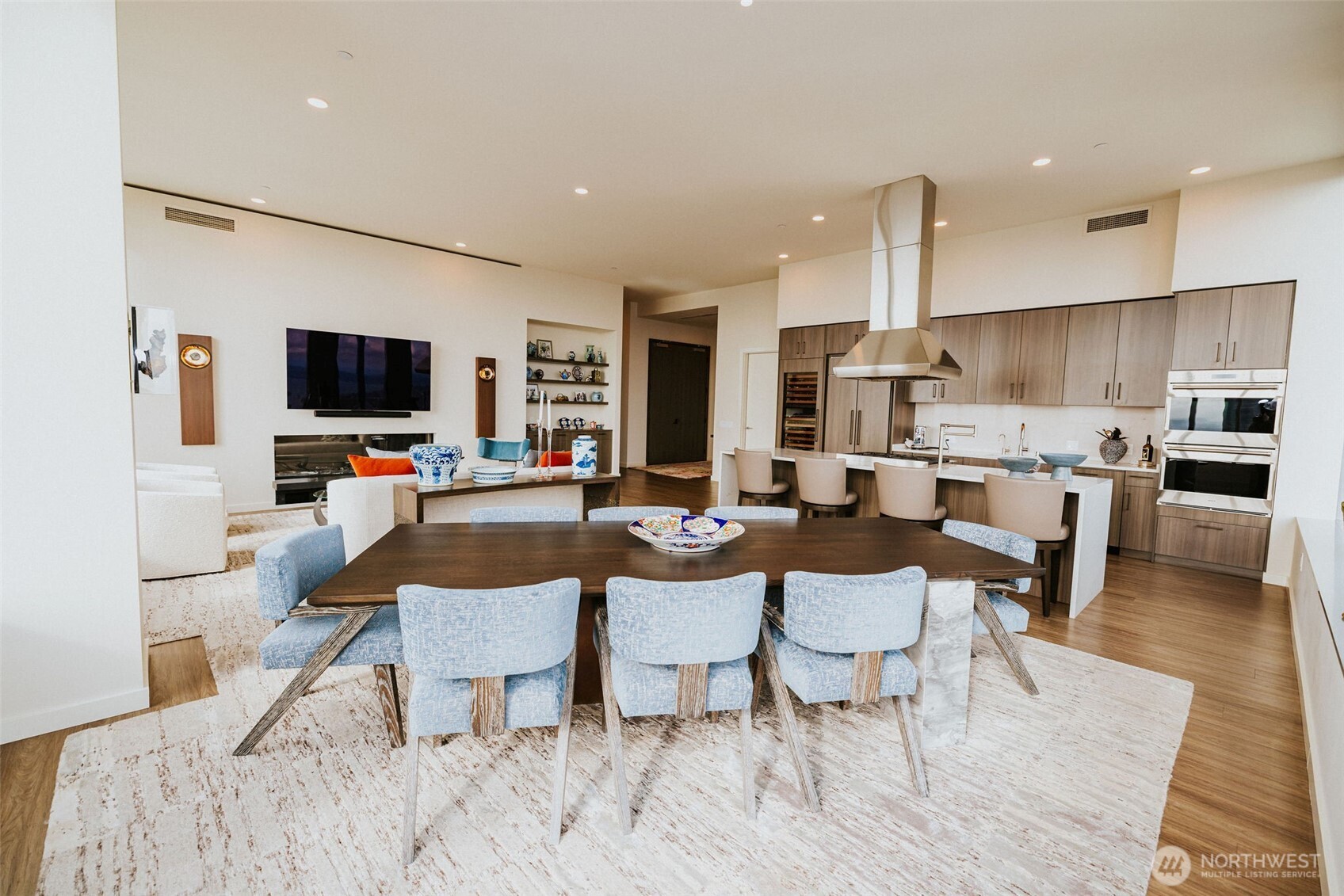 1340 4th Avenue, Unit 5803 Seattle, WA 98101 - Photo 8 of 39 a living room with furniture a flat screen tv and kitchen view