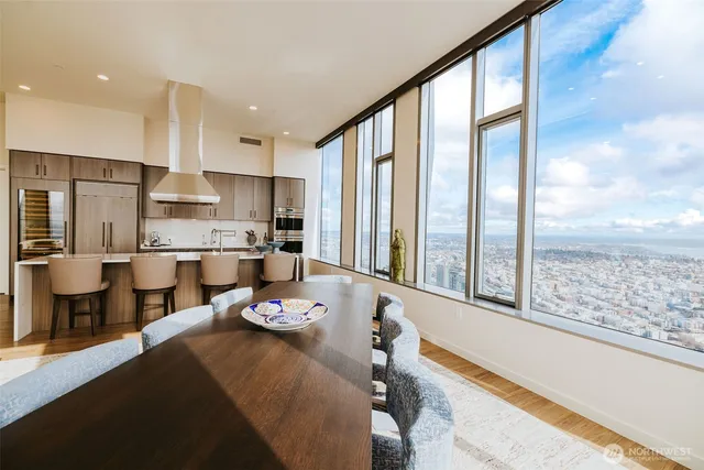 a large kitchen with a large window and stainless steel appliances