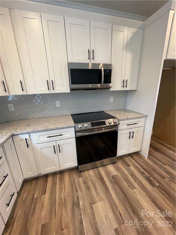 580 Crescent Road Salisbury, NC 28146 - Photo 11 of 38 a kitchen with stainless steel appliances white cabinets and a stove