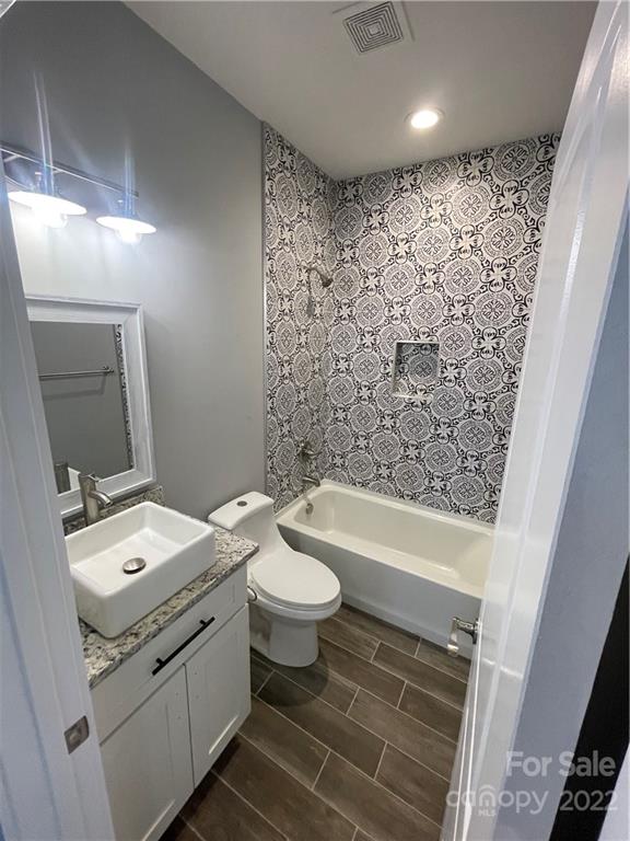 580 Crescent Road Salisbury, NC 28146 - Photo 12 of 38 a bathroom with a granite countertop toilet a sink and a bathtub