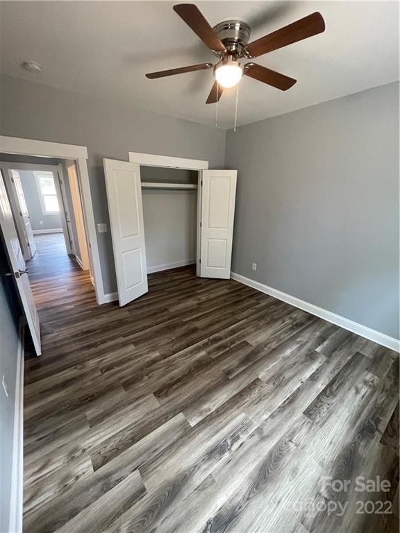 580 Crescent Road Salisbury, NC 28146 - Photo 14 of 38 a view of an empty room with wooden floor and a ceiling fan