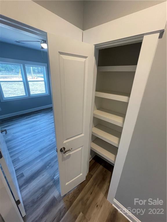 580 Crescent Road Salisbury, NC 28146 - Photo 18 of 38 a view of walk in closet with wooden floor and stairs