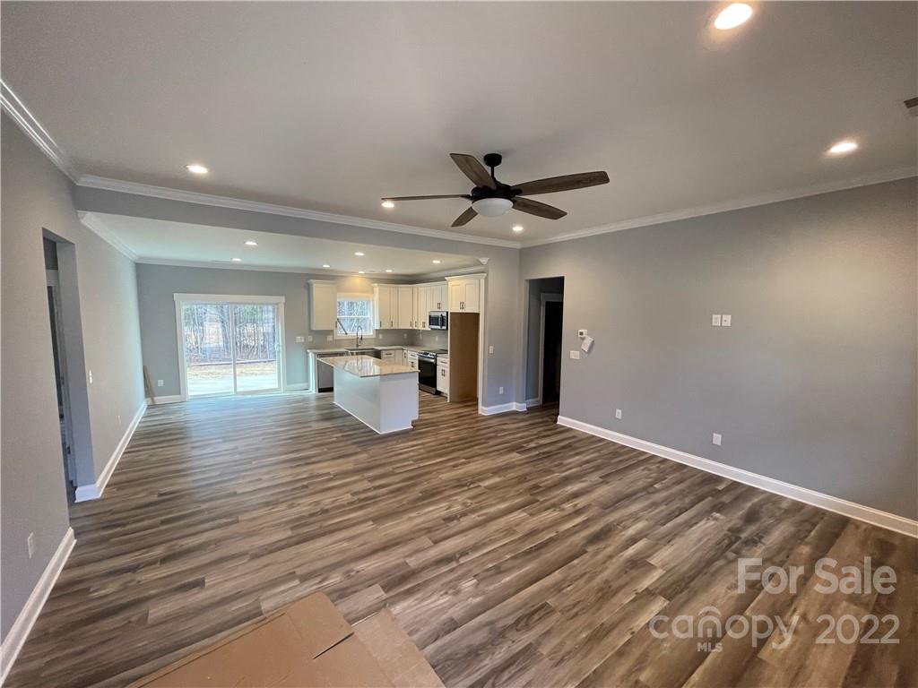 580 Crescent Road Salisbury, NC 28146 - Photo 7 of 38 a view of an empty room with wooden floor and a window