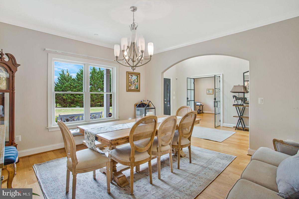 5 Jessie Road Harwood, MD 20776 - Photo 23 of 87 a view of a dining room with furniture a chandelier and wooden floor