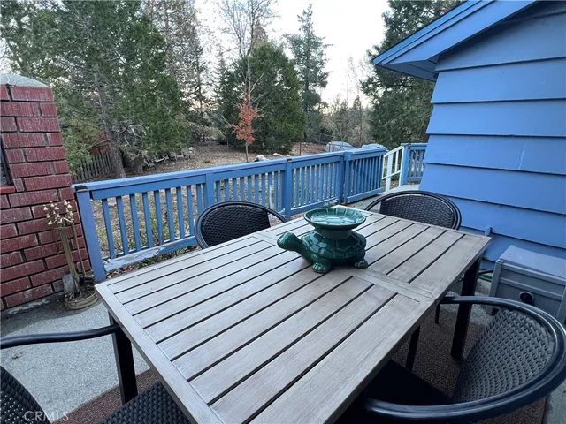 a view of balcony with wooden floor outdoor seating and stairs