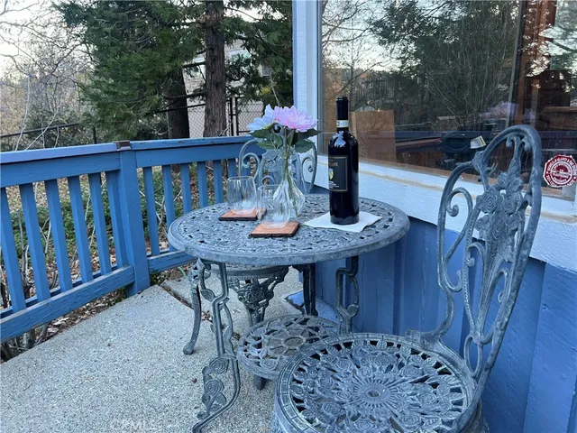 a view of balcony with wooden floor and outdoor seating