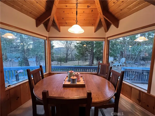a dining room with furniture a chandelier and wooden floor