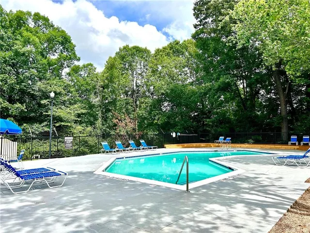 a view of a swimming pool with a lounge chair