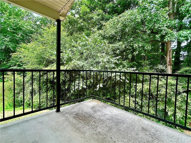 a view of an empty room with a fireplace and a window