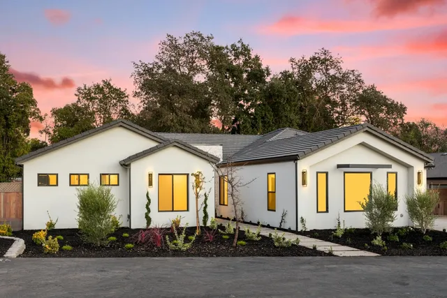 a front view of a house with trees