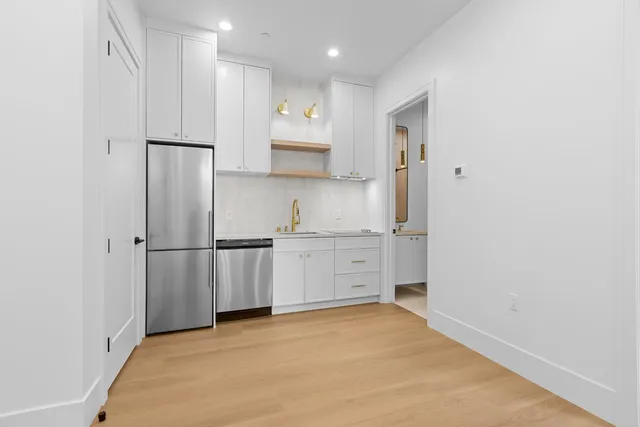a bathroom with a sink and mirror with toilet