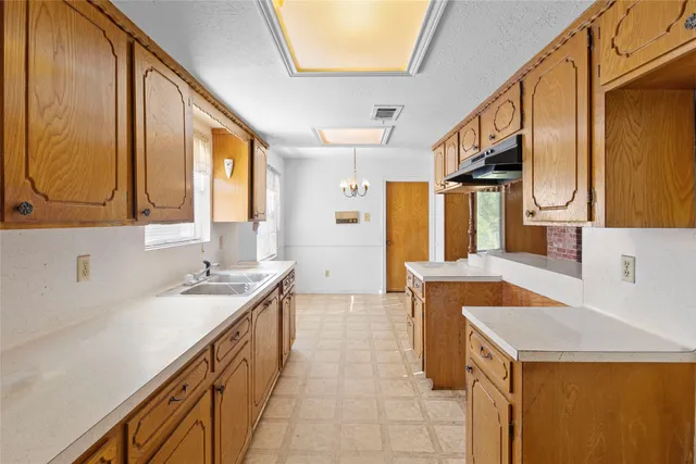 a kitchen with a sink a stove and a refrigerator