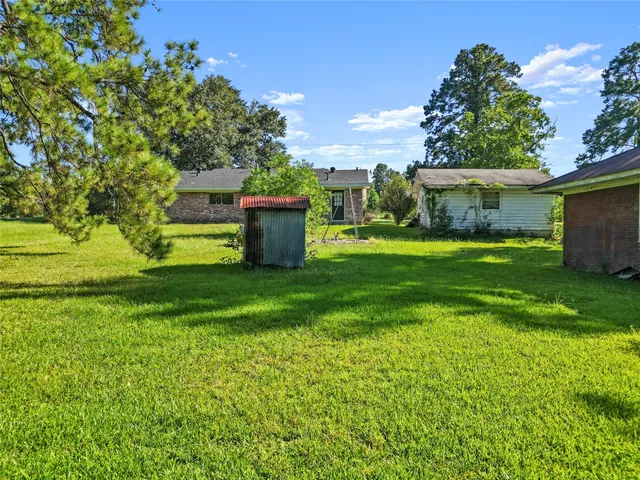 a view of a house with a yard and a garage