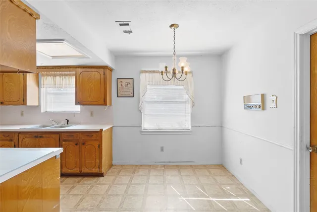 a view of a kitchen with a sink dishwasher and wooden floor