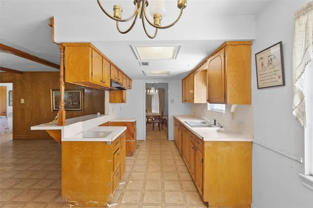 a spacious bathroom with a granite countertop sink and a mirror