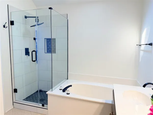 a bathroom with a tub and a shower