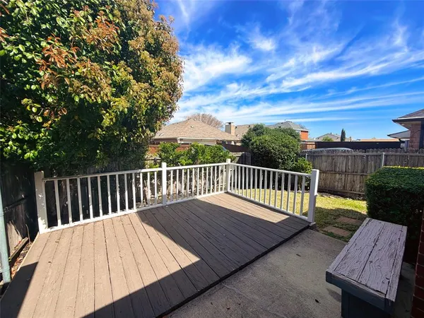 a view of balcony with wooden floor and fence