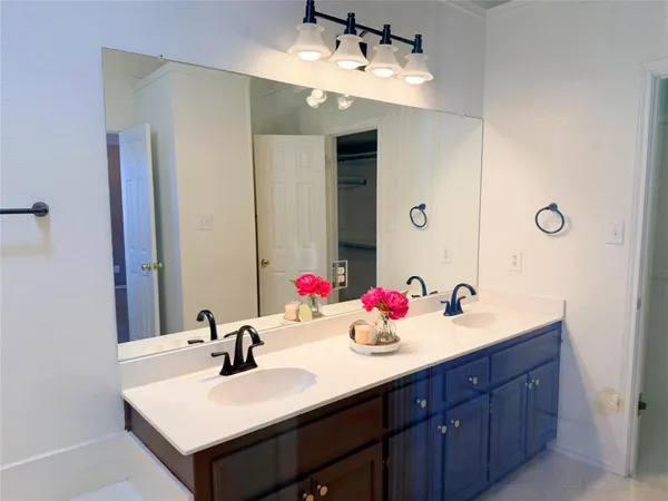 a bathroom with a sink double vanity and a mirror