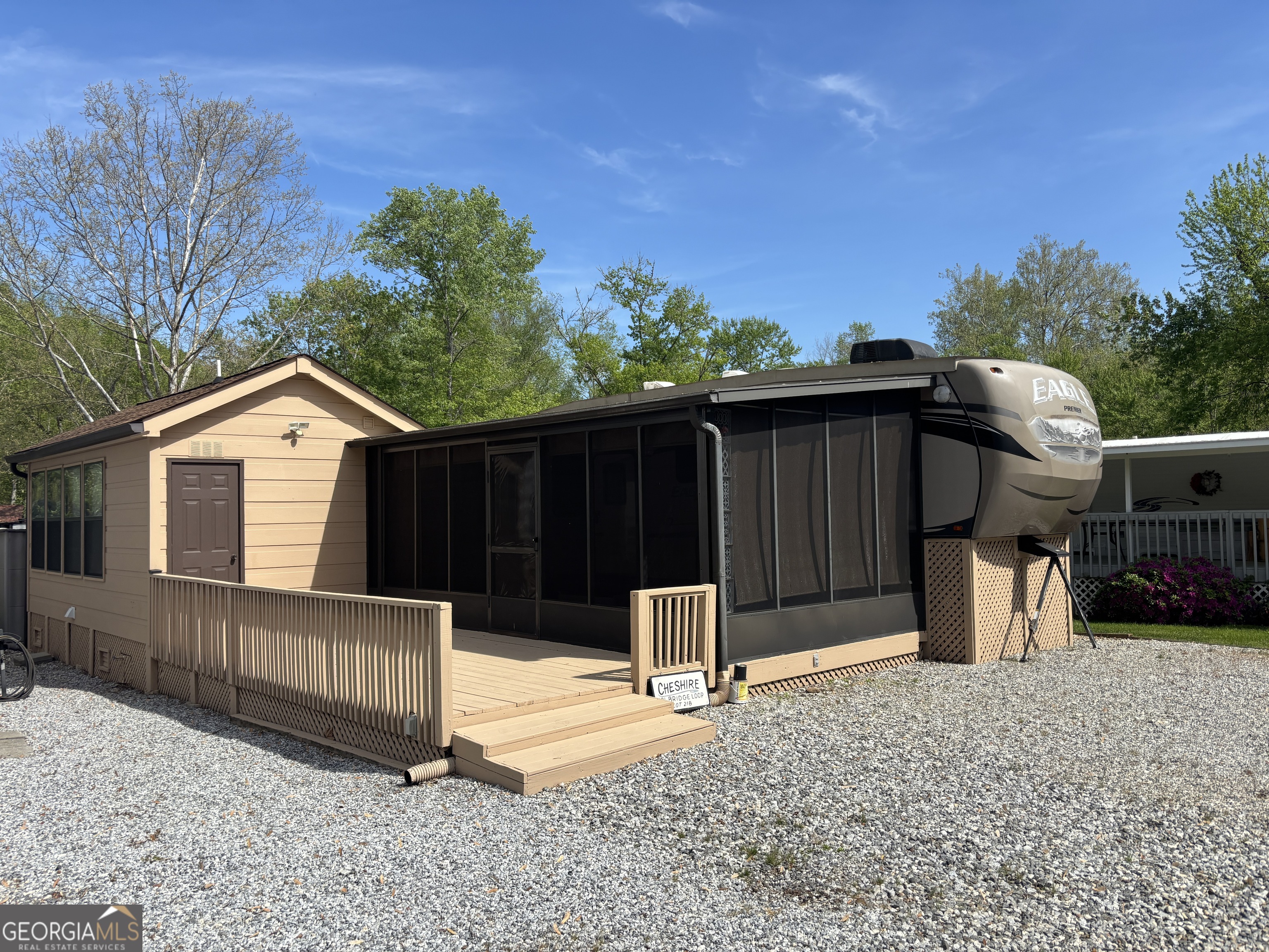 a view of a house with a yard and wooden fence