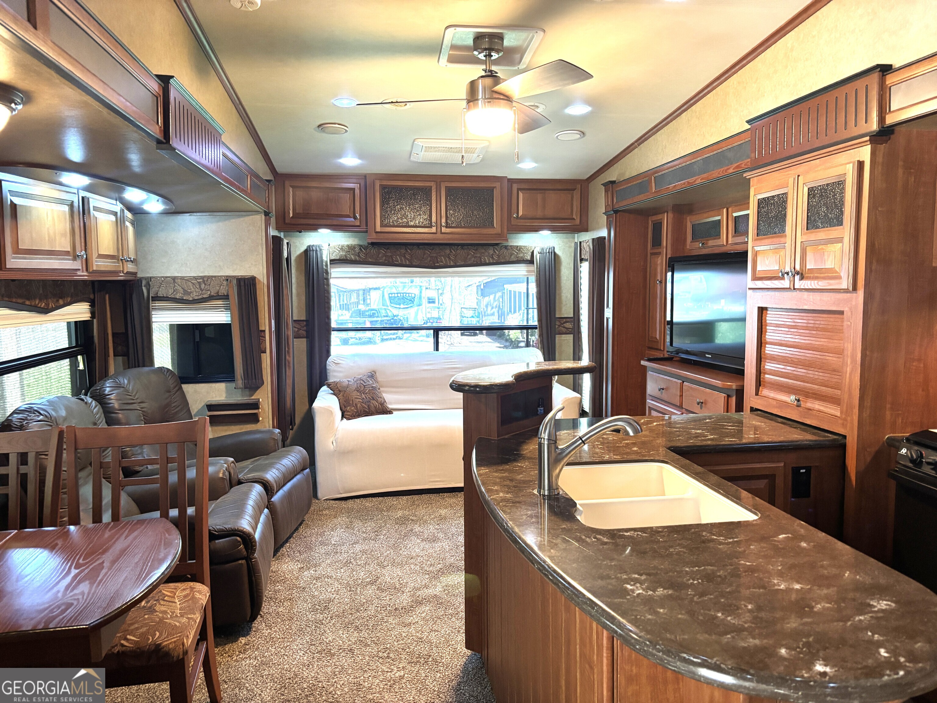 101 Bridge Loop Drive Cleveland, GA 30528 - Photo 13 of 93 a living room with stainless steel appliances granite countertop furniture a fireplace a flat screen tv and a refrigerator