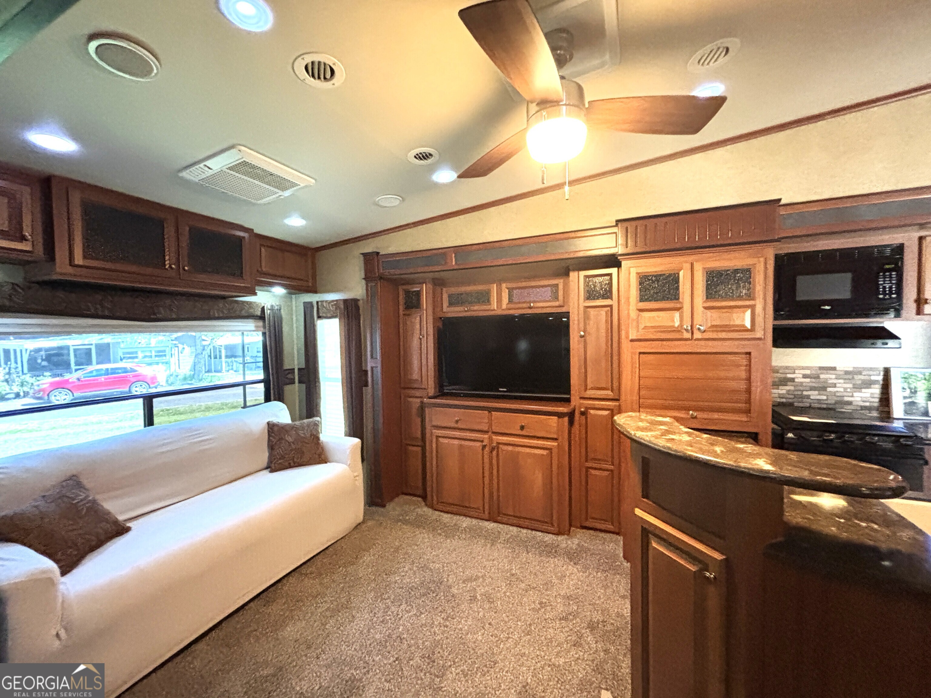 101 Bridge Loop Drive Cleveland, GA 30528 - Photo 22 of 93 a living room with stainless steel appliances kitchen island granite countertop furniture and a flat screen tv