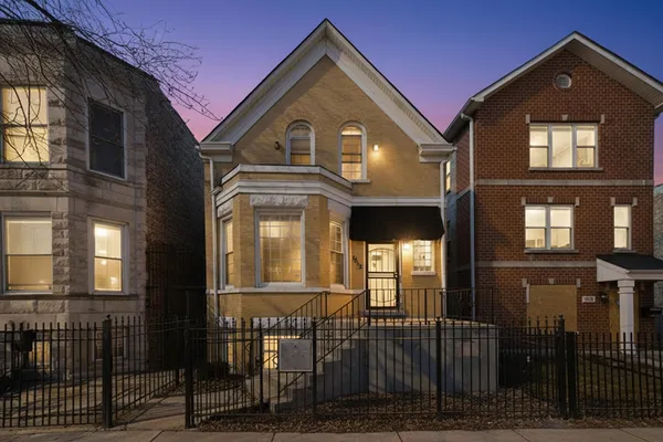 a view of a brick house with large windows