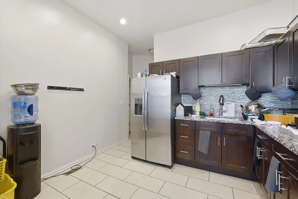 a kitchen with stainless steel appliances granite countertop a refrigerator sink and cabinets