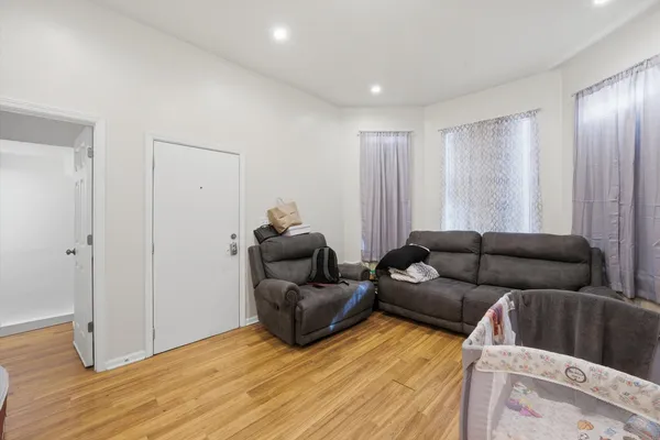a living room with furniture and wooden floor