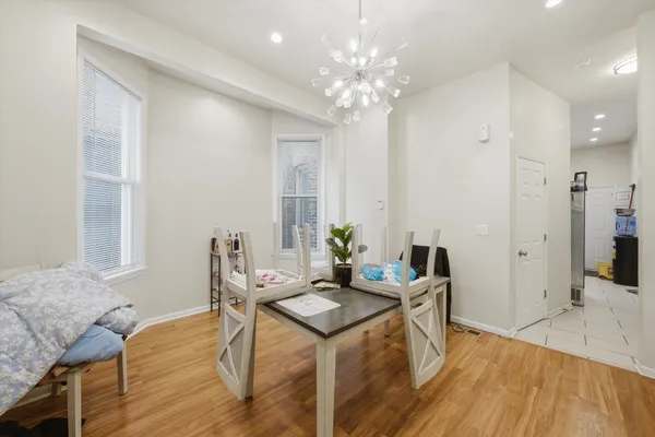 a living room with furniture and a chandelier