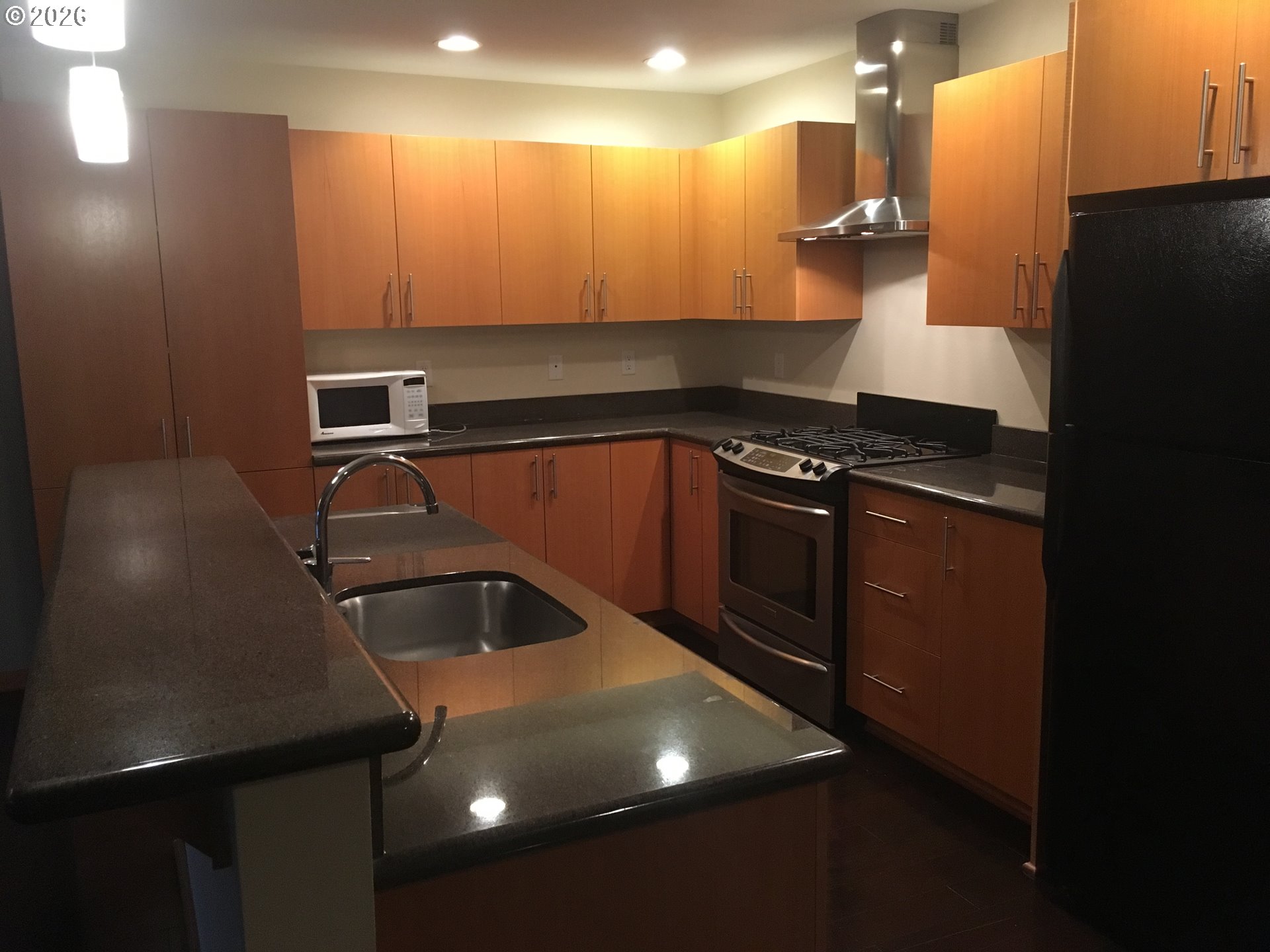 7910 Southwest 31st Avenue, Unit 306 Portland, OR 97219 - Photo 11 of 19 a kitchen with a sink and cabinets