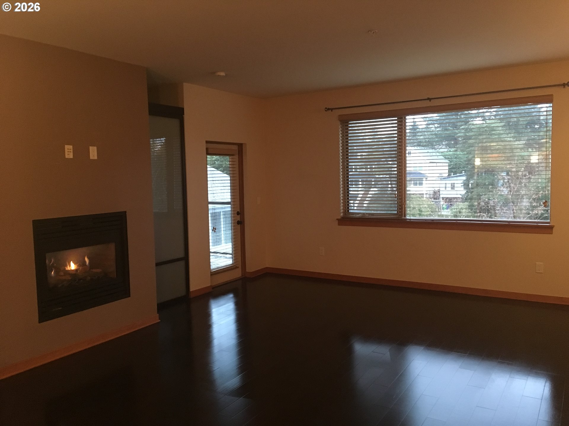 7910 Southwest 31st Avenue, Unit 306 Portland, OR 97219 - Photo 3 of 19 a view of an empty room with wooden floor and a window