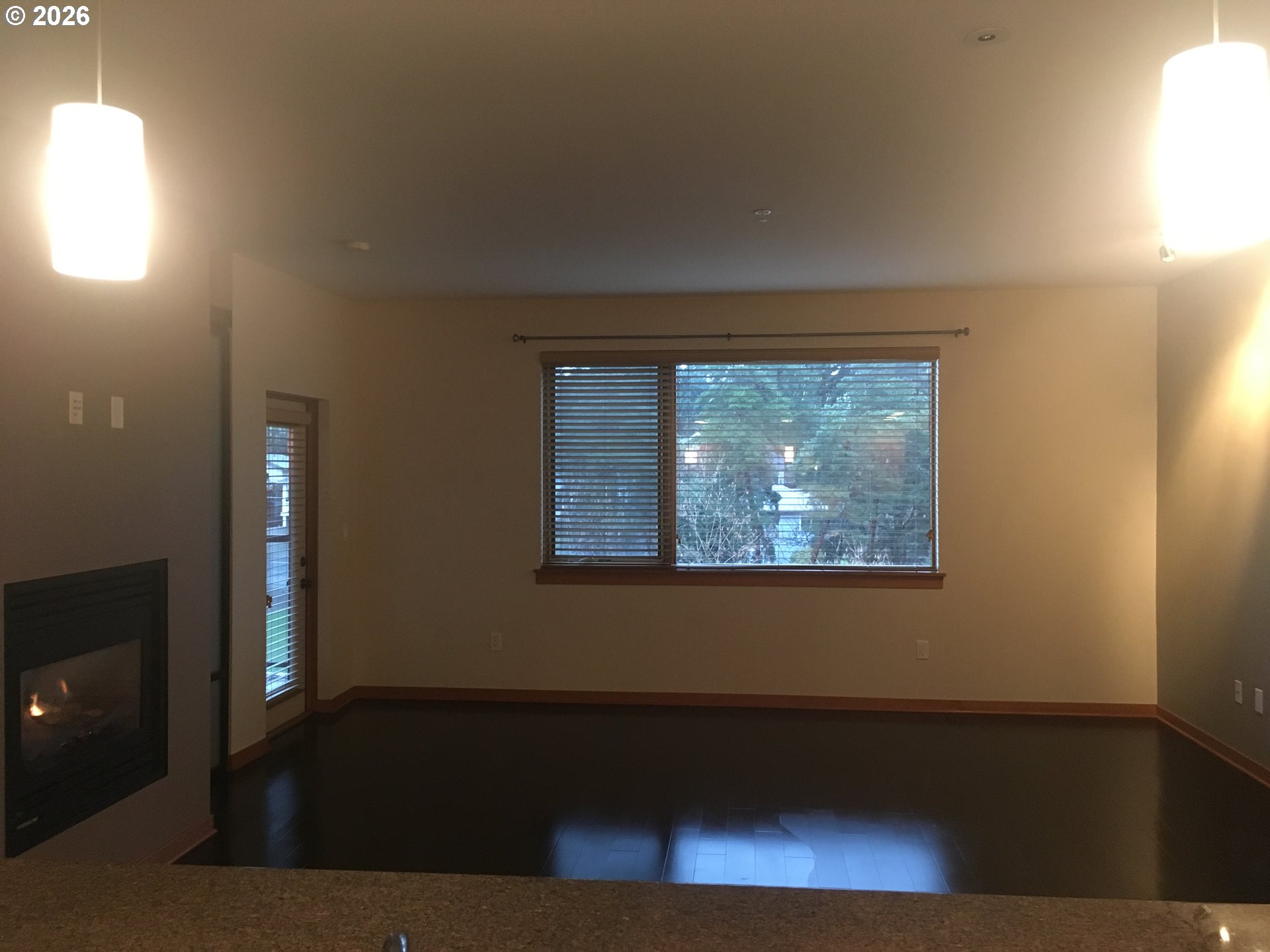 7910 Southwest 31st Avenue, Unit 306 Portland, OR 97219 - Photo 7 of 19 a view of an empty room with wooden floor and a window