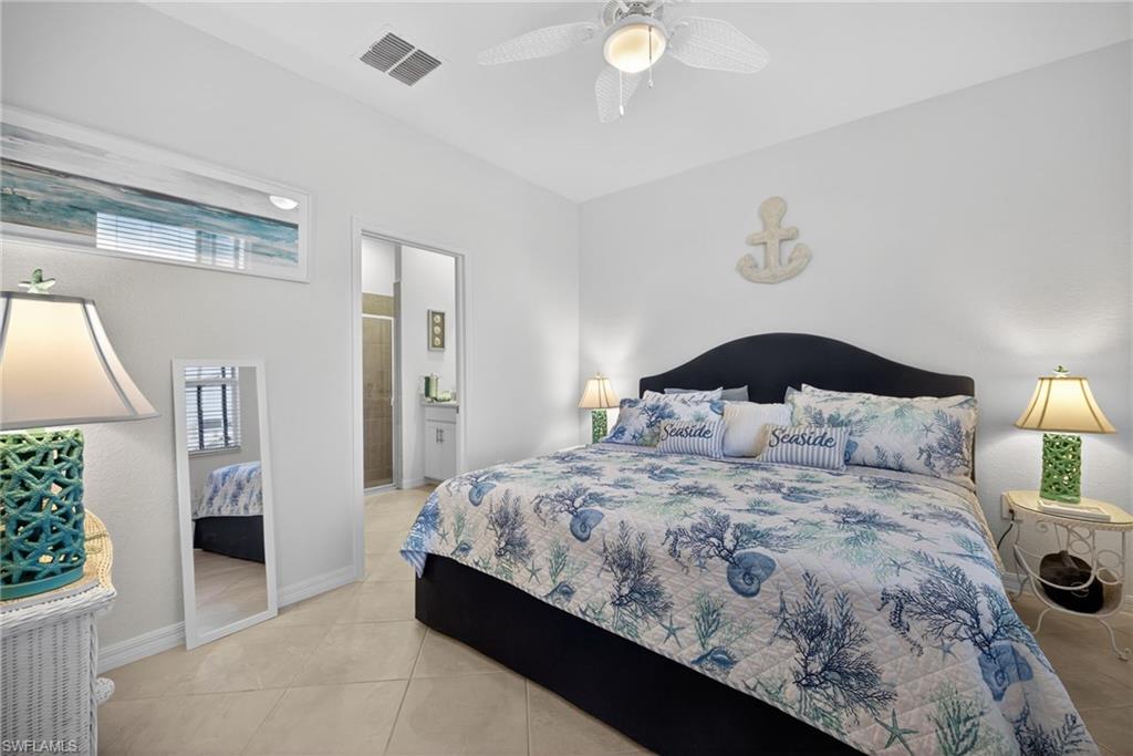 2323 Dragonfruit Way Naples, FL 34120 - Photo 13 of 32 a bedroom with a bed and a window