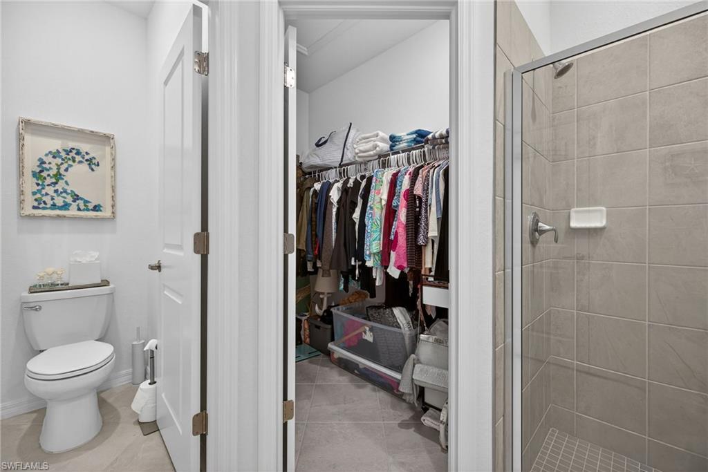 2323 Dragonfruit Way Naples, FL 34120 - Photo 16 of 32 a view of a walk in closet and bathroom