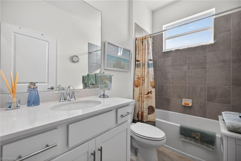 2323 Dragonfruit Way Naples, FL 34120 - Photo 19 of 32 a bathroom with a sink a toilet and shower