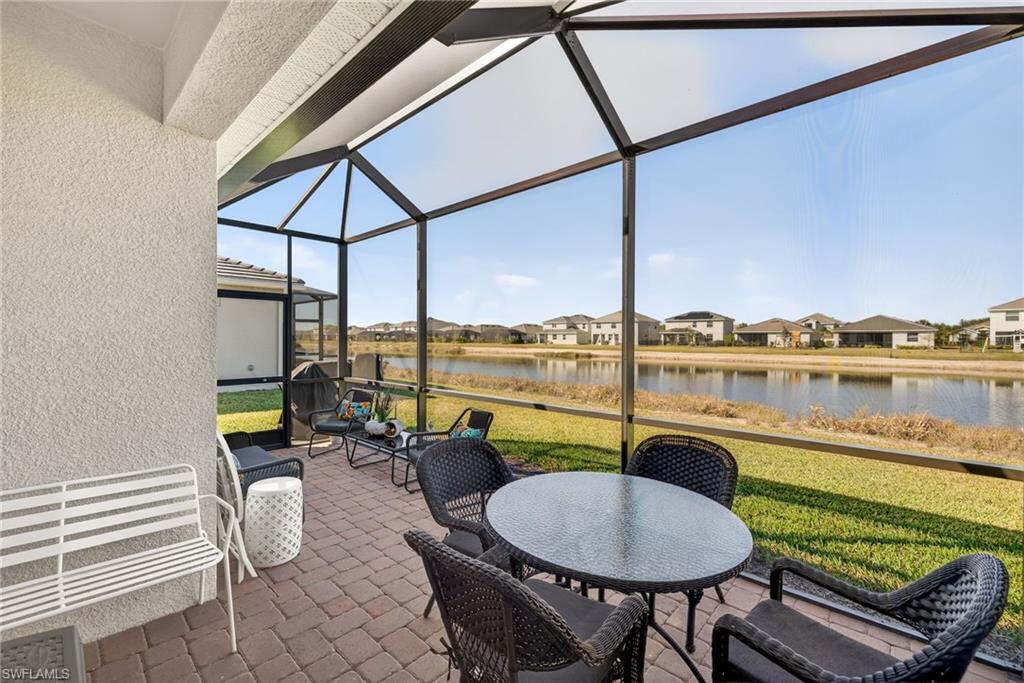 2323 Dragonfruit Way Naples, FL 34120 - Photo 21 of 32 a balcony with furniture and view of lake