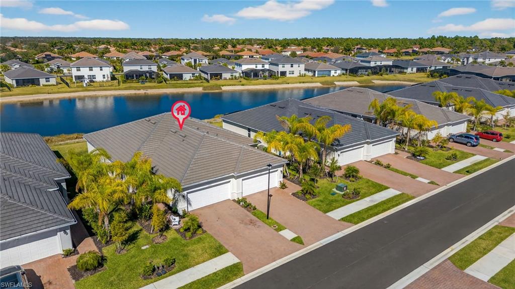 2323 Dragonfruit Way Naples, FL 34120 - Photo 23 of 32 an aerial view of a residential houses with outdoor space and lake view