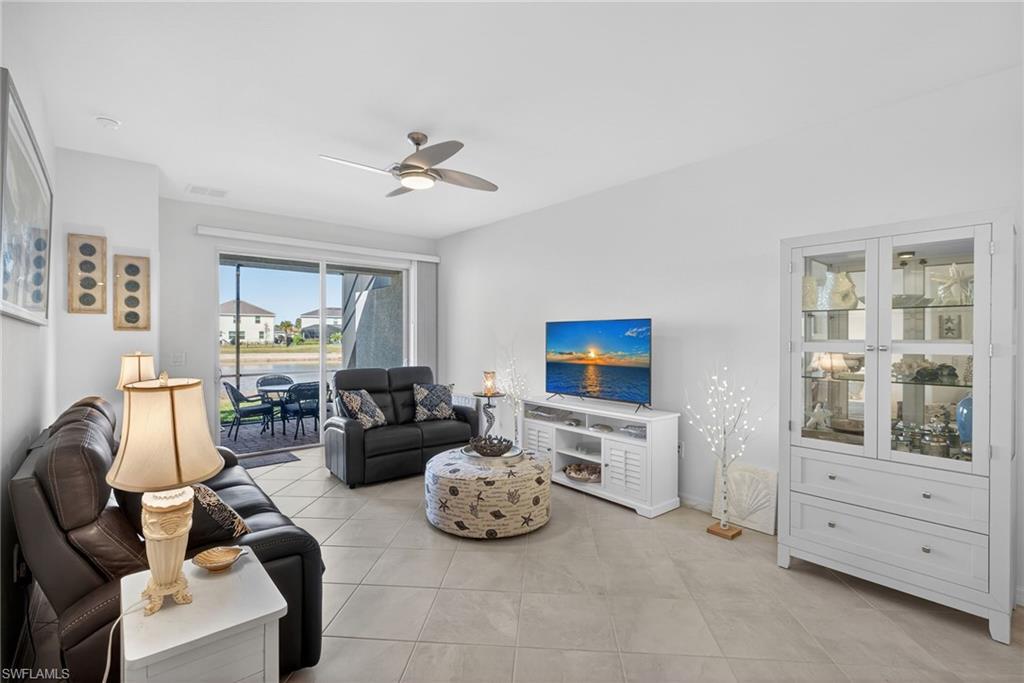 2323 Dragonfruit Way Naples, FL 34120 - Photo 3 of 32 a living room with furniture a flat screen tv and a window