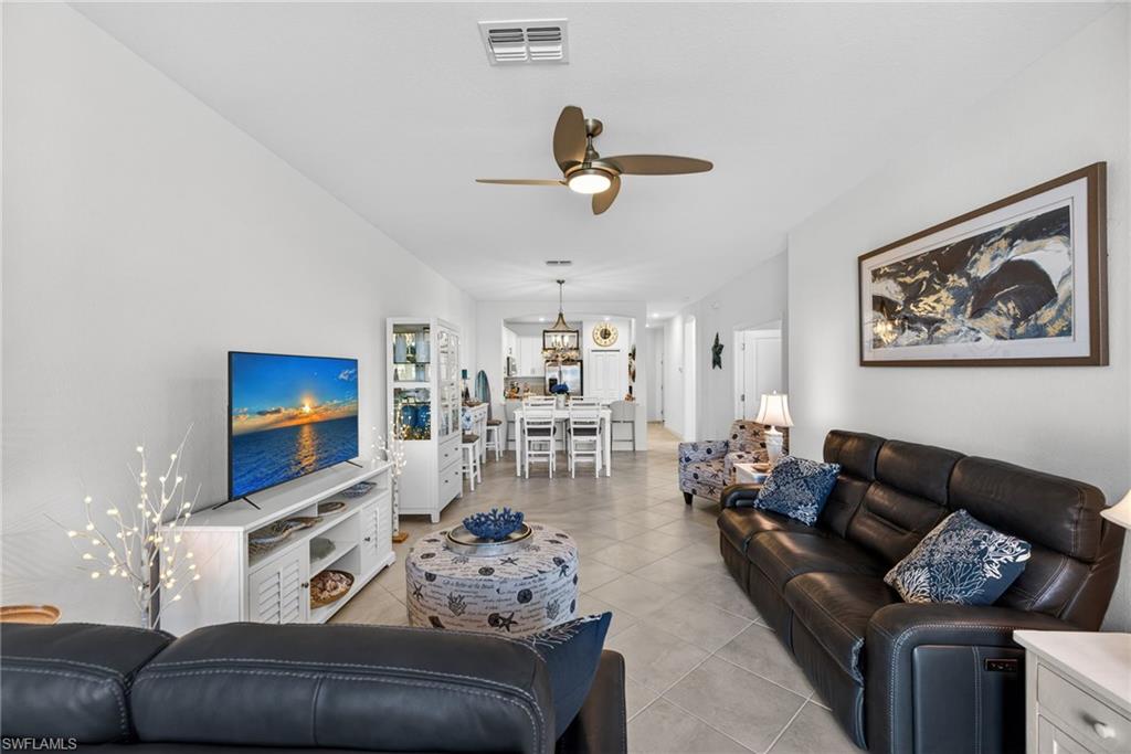2323 Dragonfruit Way Naples, FL 34120 - Photo 6 of 32 a living room with furniture and a flat screen tv