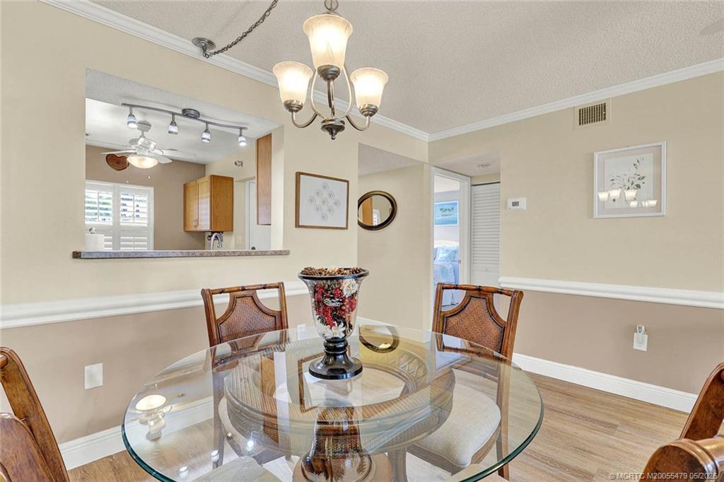 1950 Southwest Palm City Road, Unit 2102 Stuart, FL 34994 - Photo 17 of 55 a view of a dining room with furniture and chandelier