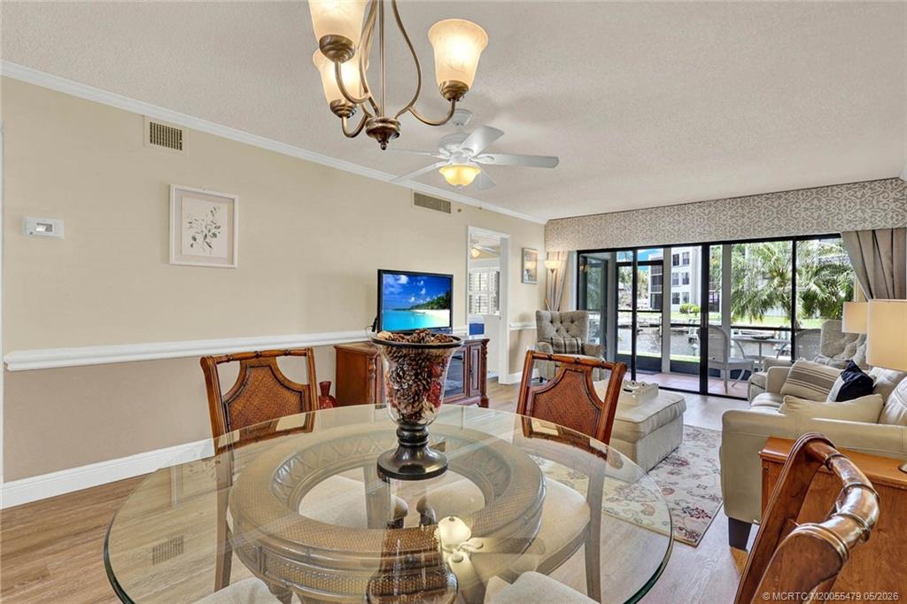 1950 Southwest Palm City Road, Unit 2102 Stuart, FL 34994 - Photo 18 of 55 a living room with furniture a flat screen tv and a large window