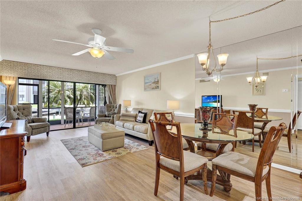 1950 Southwest Palm City Road, Unit 2102 Stuart, FL 34994 - Photo 19 of 55 a view of a dining room with furniture wooden floor and chandelier