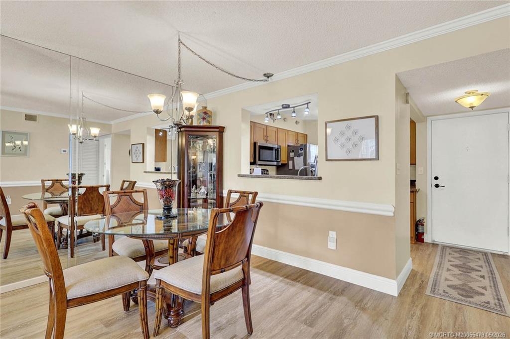 1950 Southwest Palm City Road, Unit 2102 Stuart, FL 34994 - Photo 20 of 55 a view of a dining room with furniture and chandelier
